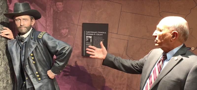 Dr. John Marszalek, executive director of the Ulysses S. Grant Association, gestures to a lifesize statue of Ulysses S. Grant as a soldier.