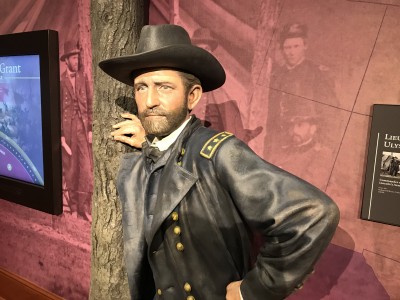 Statue of Ulysses S. Grant leaning against a tree.