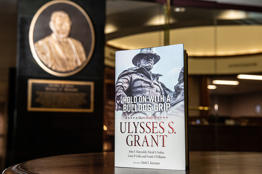 Copy of the book Hold on With a Bulldog Grip sitting on a table.