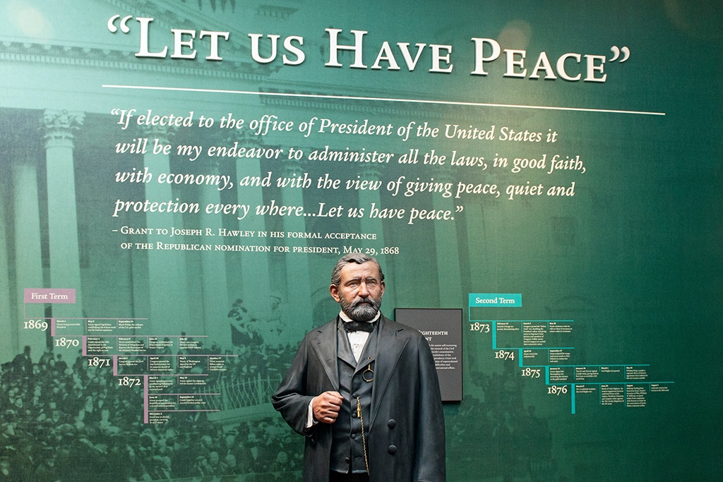 Statue of U.S. Grant on display in front of a quote on the wall reading "Let us have peace".